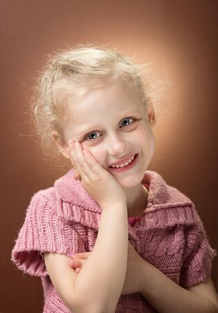 Little child, blonde curly girl with ring on her fingerの写真素材