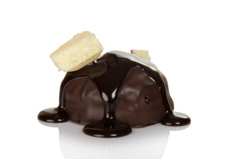 Candy with praline and melted chocolate, piece of white on top, isolated on white backgroundの写真素材