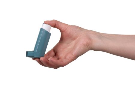 Small portable inhaler in female hand isolated on white backgroundの写真素材