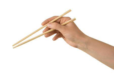 Japanese wooden sticks in female hand isolated on white backgroundの写真素材