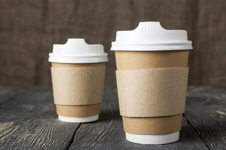 Special container  for coffee to takeaway, on old wooden surfaceの写真素材