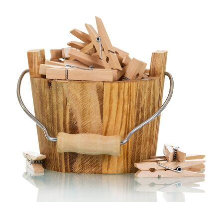 Bucket with wooden clothespins close-up isolated on white background.の写真素材