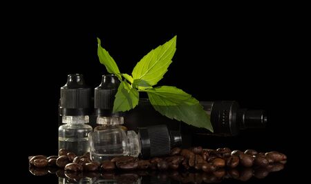 The coffee liquid and electronic cigarette isolated on black backgroundの写真素材