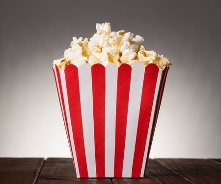 large square box filled with top popcorn on a gray backgroundの写真素材