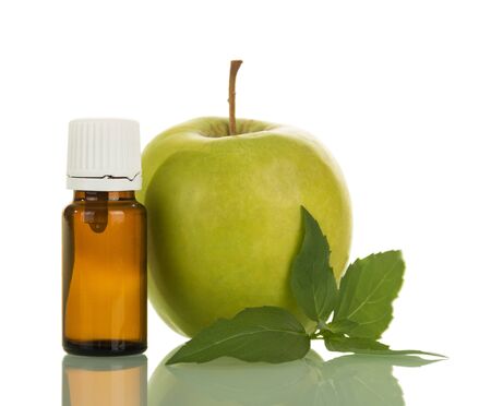 Bottle with liquid for smoking electronic cigarettes, and an apple, isolated on white backgroundの写真素材