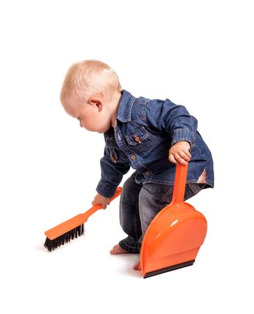 Little boy with broom and dustpan, isolated on white backgroundの写真素材
