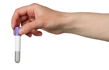 Blue vacuum tube in hand isolated on white backgroundの写真素材