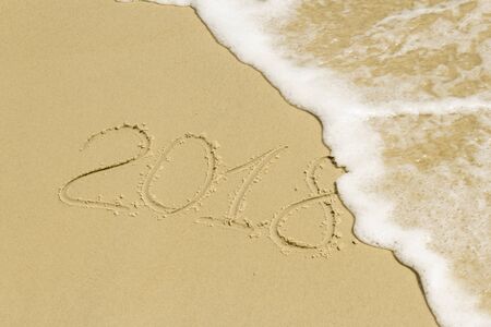Summer inscription on sand with sea foamの写真素材