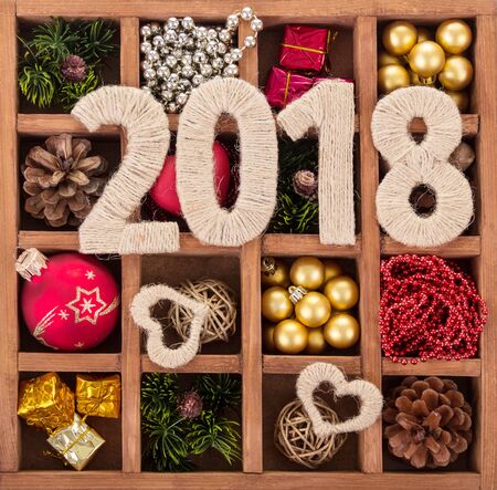 Figures 2018 and hearts decorated with a rope, box with Christmas ornamentsの写真素材