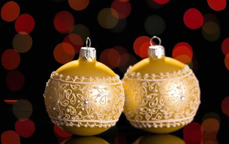 Beautiful Christmas beige balls with a pattern on flickering backgroundの写真素材
