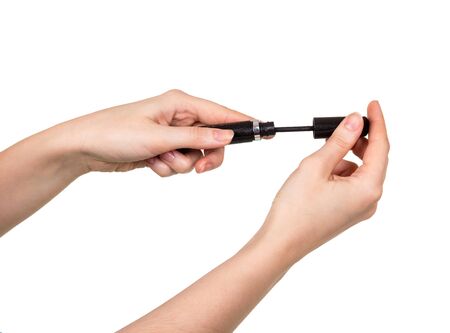 Mascara in female hands isolated on white background.の写真素材