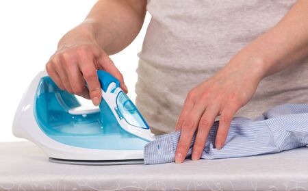 Hands of a woman stroking laundry, isolated on whiteの写真素材