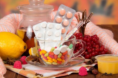 Products for tea and medicines for colds on the tableの写真素材