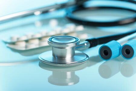 Medical set for diagnosis, phonendoscope and test tube, on blue light backgroundの写真素材
