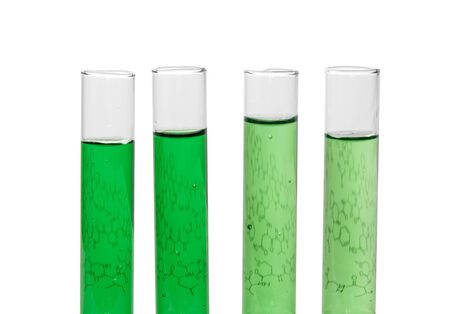 Four test tubes with green liquids and a sheet of paper with formulas isolated on white background.の写真素材