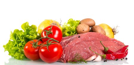 Piece of raw beef, tomato, mushrooms, onion, lettuce, dill and spices isolated on white background.の写真素材
