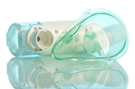 Compact electronic mesh inhaler and mask on blue backgroundの写真素材