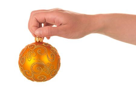Beautiful bright Christmas toy in female hand, isolated on white backgroundの写真素材