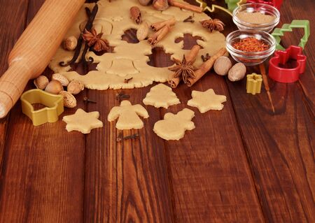 Figures from dough ready for baking, against the background of wooden tableの写真素材