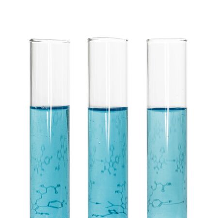 Three test tubes with blue liquids and a sheet of paper with formulas isolated on white background.の写真素材