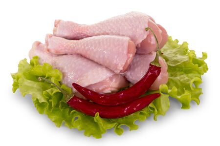 Raw chicken legs, hot pepper and lettuce leaves isolated on white background.の写真素材