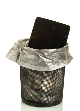 Old broken tablet in trash bin, isolated on white backgroundの写真素材