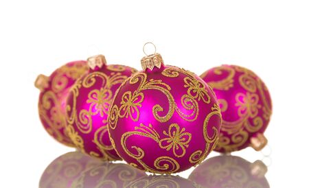 Four pink bright balls decorated with golden scroll isolated on white backgroundの写真素材