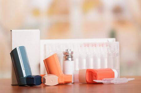 Three inhaler aerosol box and medicine on abstract pink background.の写真素材