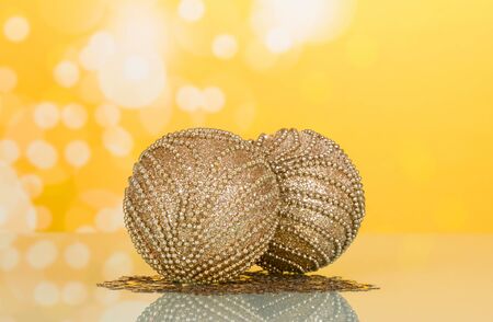 Two wonderful Christmas toys, decorated with beads, small stars, on bright yellow backgroundの写真素材
