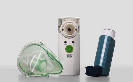 Ultrasonic mesh nebulizer and portable pocket inhalator, child mask, on gray backgroundの写真素材