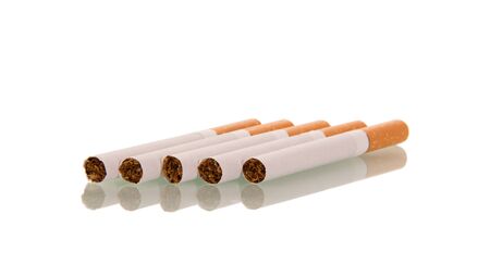 Five cigarettes with filter are nearby, isolated on white backgroundの写真素材