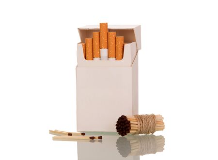Pack of cigarettes nearby to bunch of matchsticks, isolated on white backgroundの写真素材