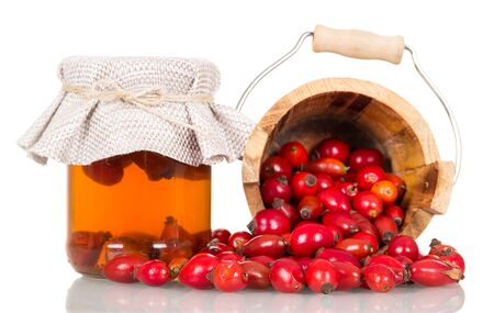 Broth briars in bank, berries crumbled out of wooden bucket isolated on white backgroundの写真素材