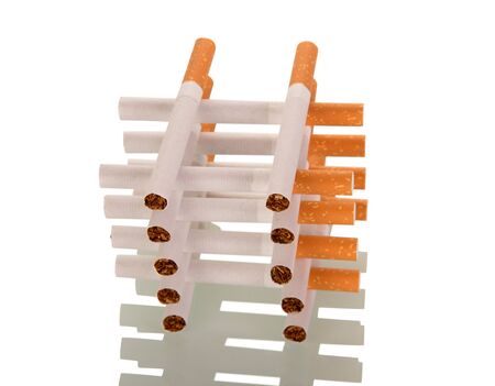 Bunch of new cigarette, one on another, isolated on white backgroundの写真素材