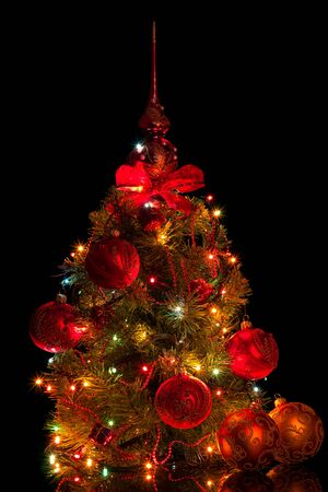 Beautiful Christmas tree garland, toys and cone, isolated on black backgroundの写真素材