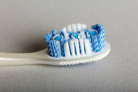 New manual toothbrush with a scraper to clean tongue, close-up, on gray backgroundの写真素材