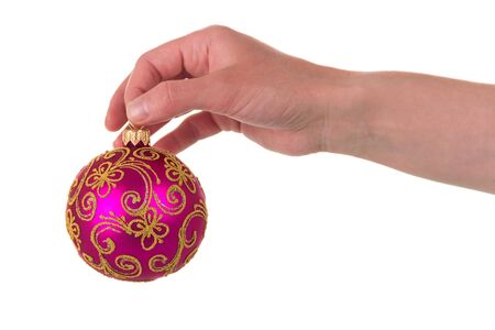 Beautiful New Year ball with patterns in hand, isolated on white backgroundの写真素材