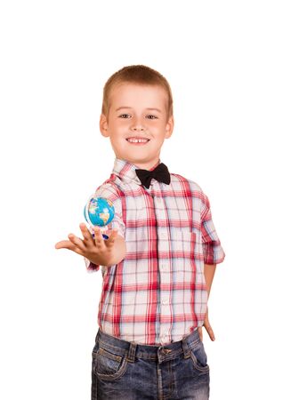 Boy in shirt with tie is holding small globe in his hand, isolated on white backgroundの写真素材