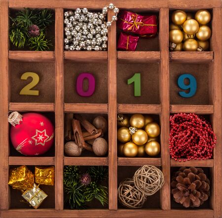 Holiday decorations for Christmas tree in wooden box with cells and numbers 2019. Backgroundの写真素材