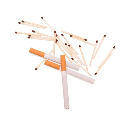 Three cigarettes with the filter and scattered beside matches, isolated on white backgroundの写真素材