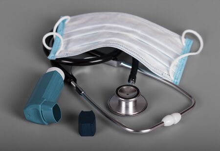 Diagnostic tool - phonendoscope, gauze bandage, inhaler with dispenser, on gray backgroundの写真素材