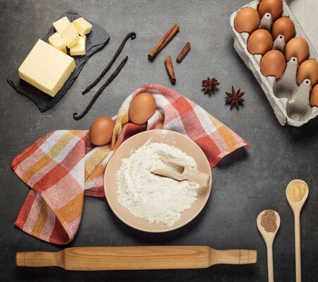 Set of products and devices for kneading dough, spices on gray work surfaceの写真素材