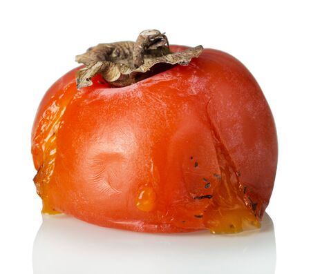 Spoiled rotten persimmon fruit isolated on white backgroundの写真素材