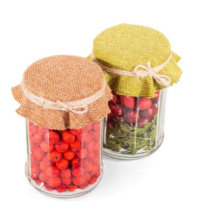 Jars with dry berries for future use isolated on white backgroundの写真素材