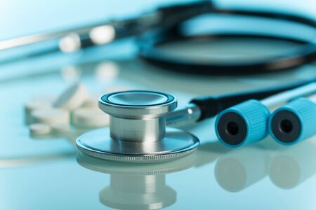 The medical device is phonendoscope for diagnostic purposes, on blue backgroundの写真素材