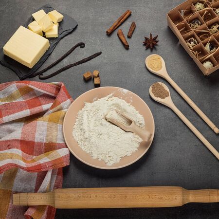 Ingredients for kneading dough and fixtures, kitchen towel on gray surfaceの写真素材