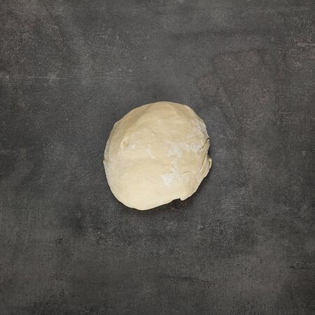 Clod of dough, ready to shape products, on grey surfaceの写真素材