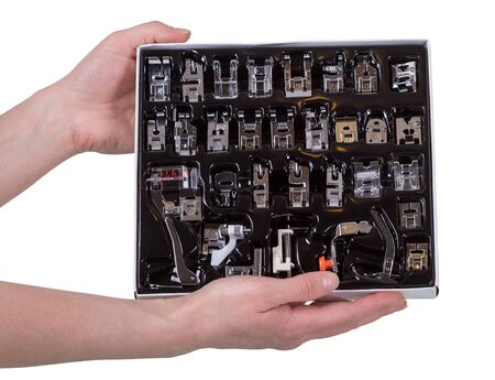 Multi-function kit presser foot to sewing machine in hands of woman isolated on white backgroundの写真素材