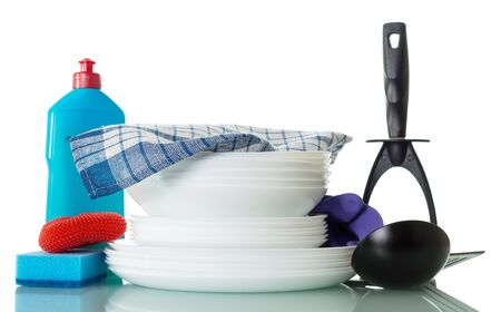 Stack of clean dishes, bottle of detergent, sponge and towel isolated on white backgroundの写真素材