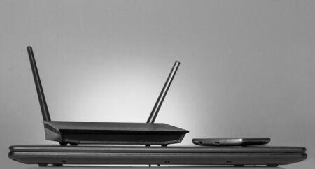 Modern digital technology-modem, computer, phone, on grey backgroundの写真素材